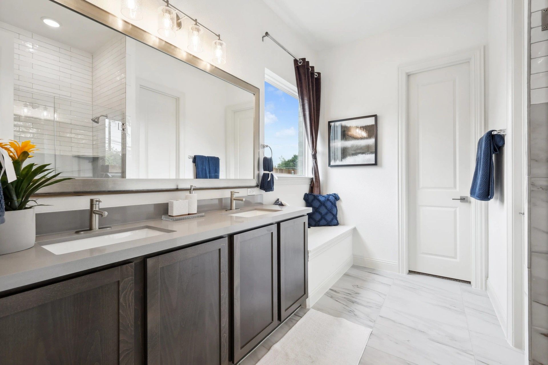 Indulge in luxury with a sleek double vanity and pristine marble flooring in Heritage Park.