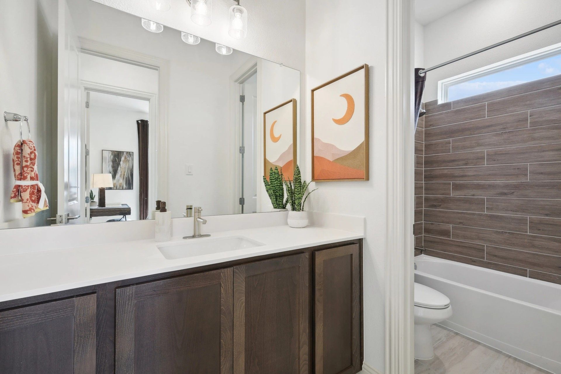Luxurious dark wood cabinetry and exquisite wood-tiled shower enhance this Heritage Park bathroom.