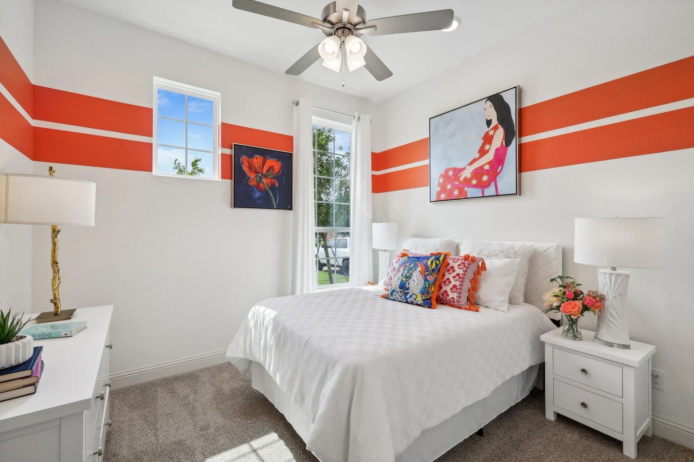 Enjoy vibrant designs and modern amenities in this Heritage Park bedroom, featuring bold orange accents and luxe finishes.