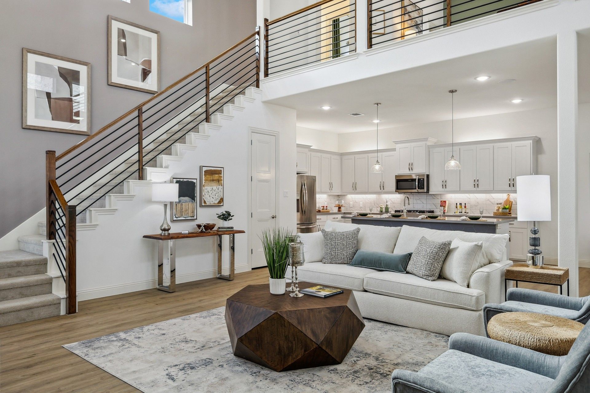 Exquisite open-plan layout with sleek staircase and airy kitchen in Solterra, Texas home.