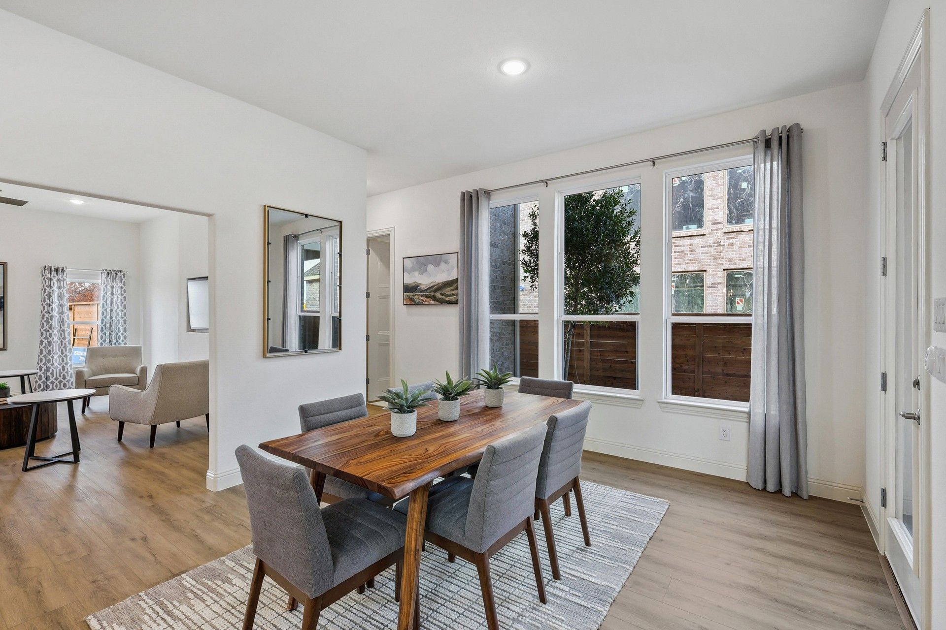 Experience luxury with floor-to-ceiling windows and exquisite hardwood flooring in Solterra, Texas.