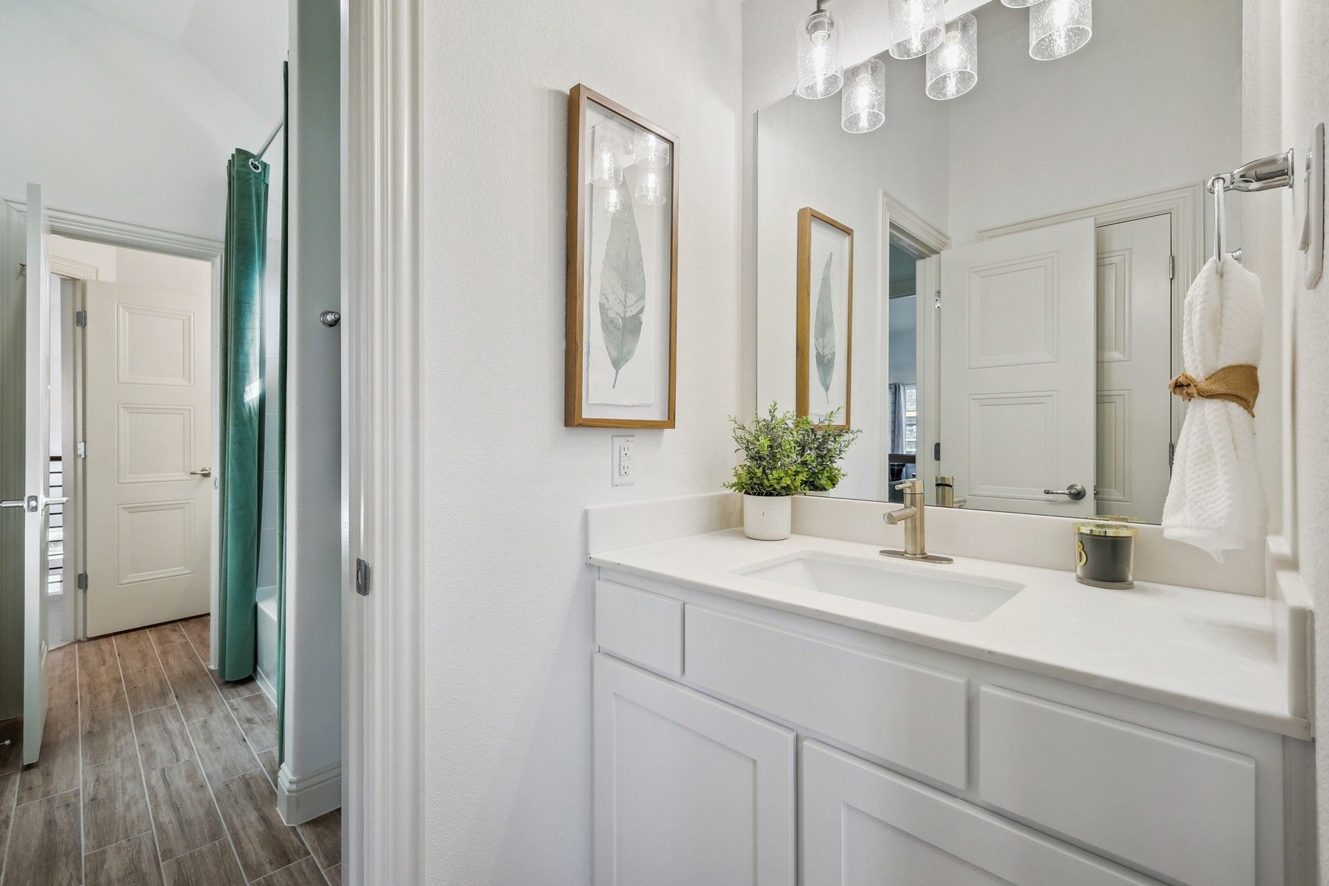 Quartz countertop and refined cabinetry elevate this Solterra Texas bathroom to unparalleled elegance.