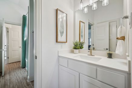 Quartz countertop and refined cabinetry elevate this Solterra Texas bathroom to unparalleled elegance.