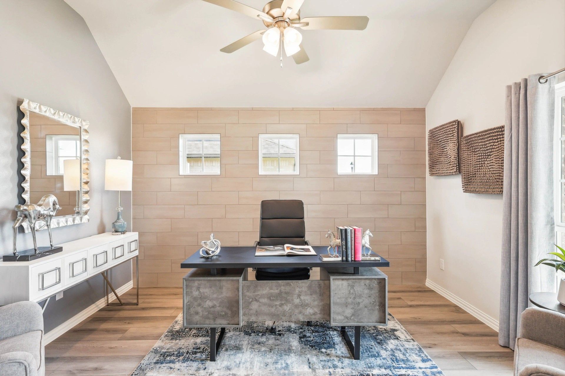 Stunning accent wall and sleek furniture enhance this elegant Pebblebrook office space.