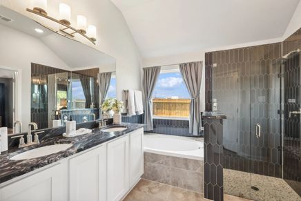 Stunning Pebblebrook bathroom features marble countertops, dual sinks, and a sleek glass shower.