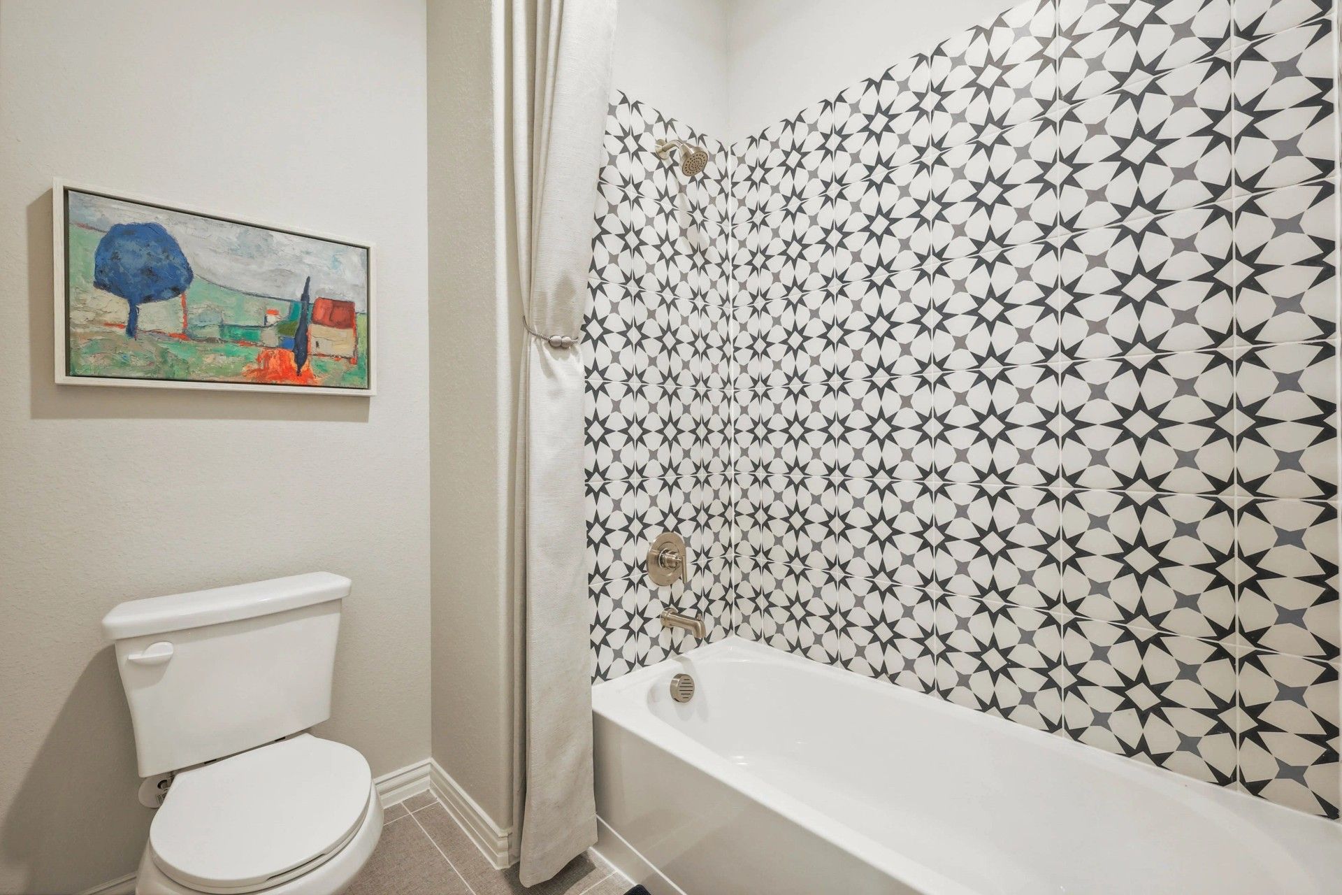 Exquisite Pebblebrook bathroom features striking geometric tiles and elegant fixtures, embodying sophisticated design.