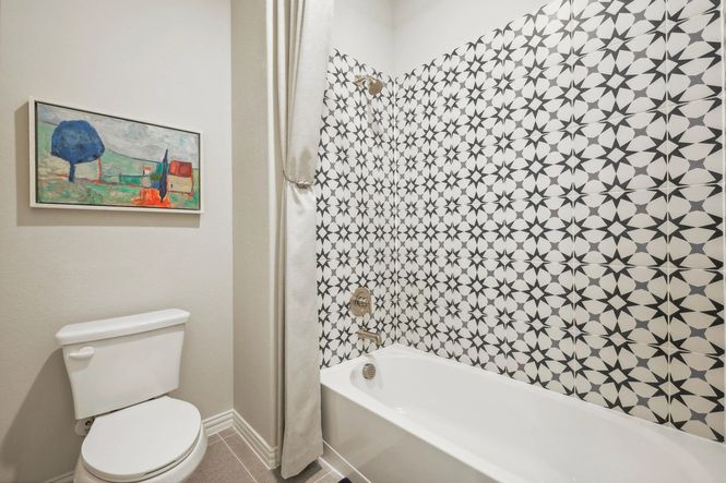 Exquisite Pebblebrook bathroom features striking geometric tiles and elegant fixtures, embodying sophisticated design.