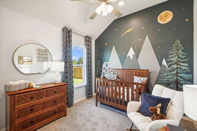 Exquisite nursery with elegant mountain mural and rich wood furnishings in Pebblebrook.