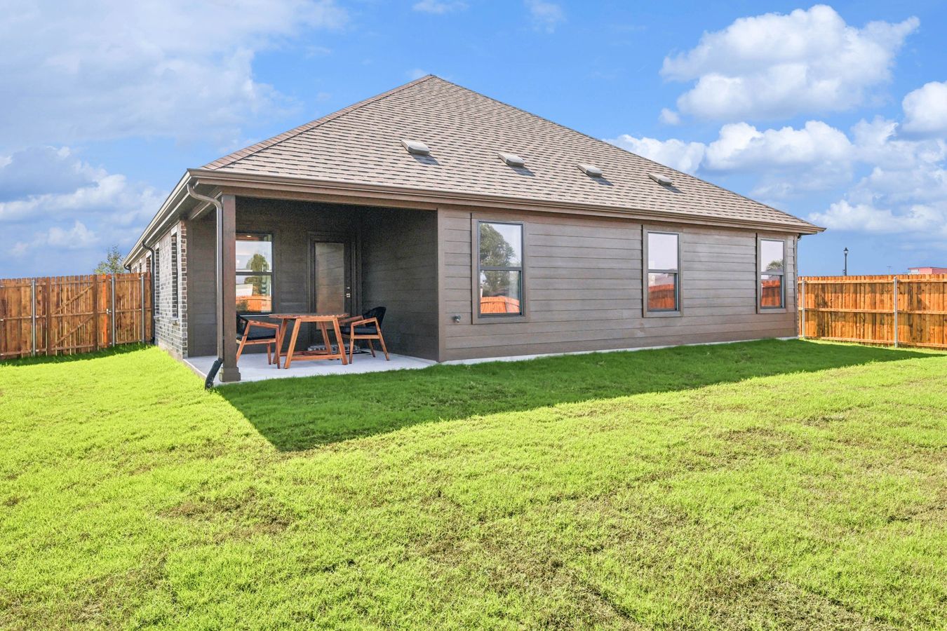 Enjoy the elegant wood siding and covered patio in Pebblebrook's lush backyard setting.