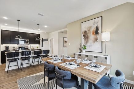 Luxurious open-plan design with sleek cabinetry, chic lighting, and exquisite furnishings at Simpson Crossing.