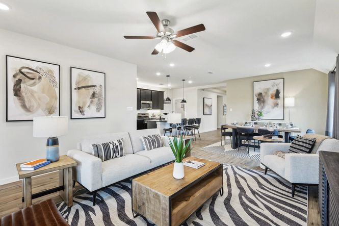 Spacious Simpson Crossing room features chic decor, wooden floors, and abstract art for luxurious living.