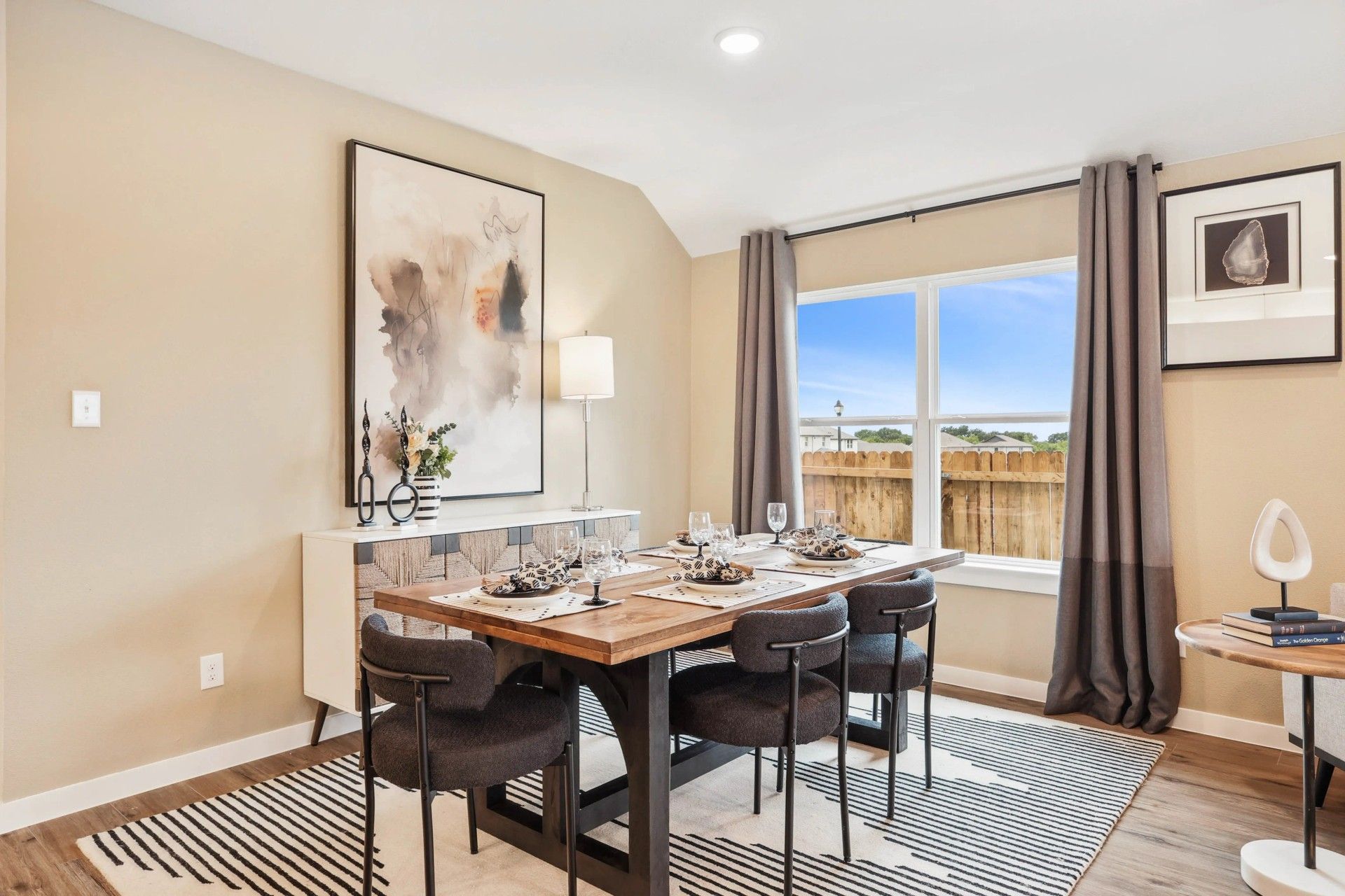 Experience refined dining with sleek modern furniture, abstract artwork, and expansive windows at Simpson Crossing.