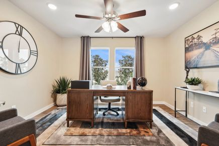 Bask in the elegance of a refined home office with rich wood tones and natural light in Simpson Crossing.