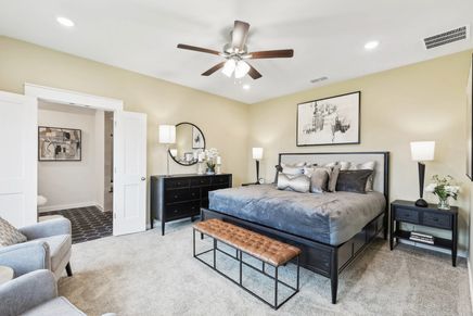 Indulge in sophisticated design with dark wood furniture and plush textures in Simpson Crossing's opulent retreat.