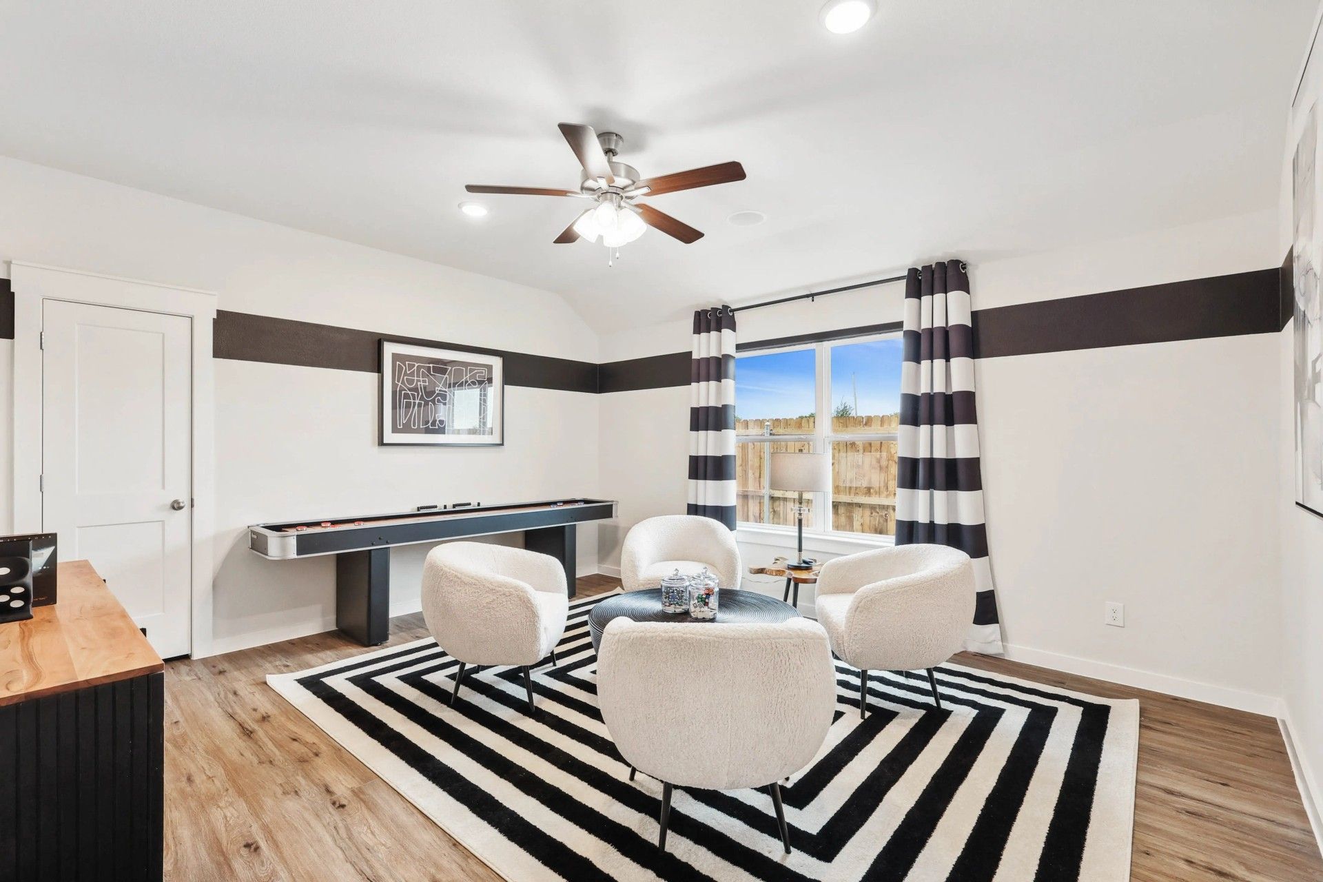 Elegant window and modern decor define this Simpson Crossing living room's allure.
