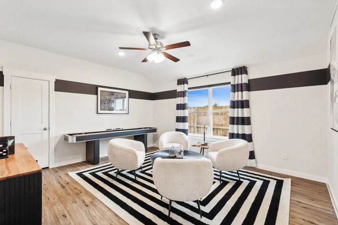 Elegant window and modern decor define this Simpson Crossing living room's allure.