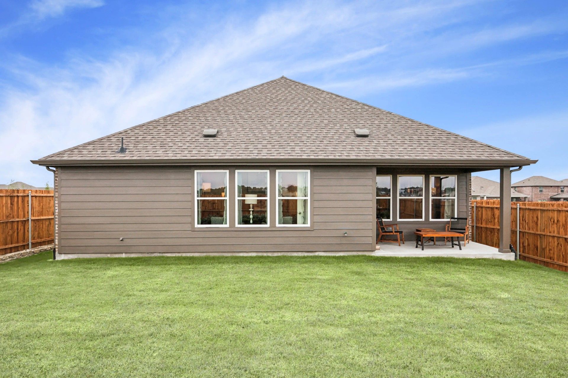 Elegant gable roof design and expansive patio in Simpson Crossing. Enjoy tranquility and privacy in a fenced backyard.