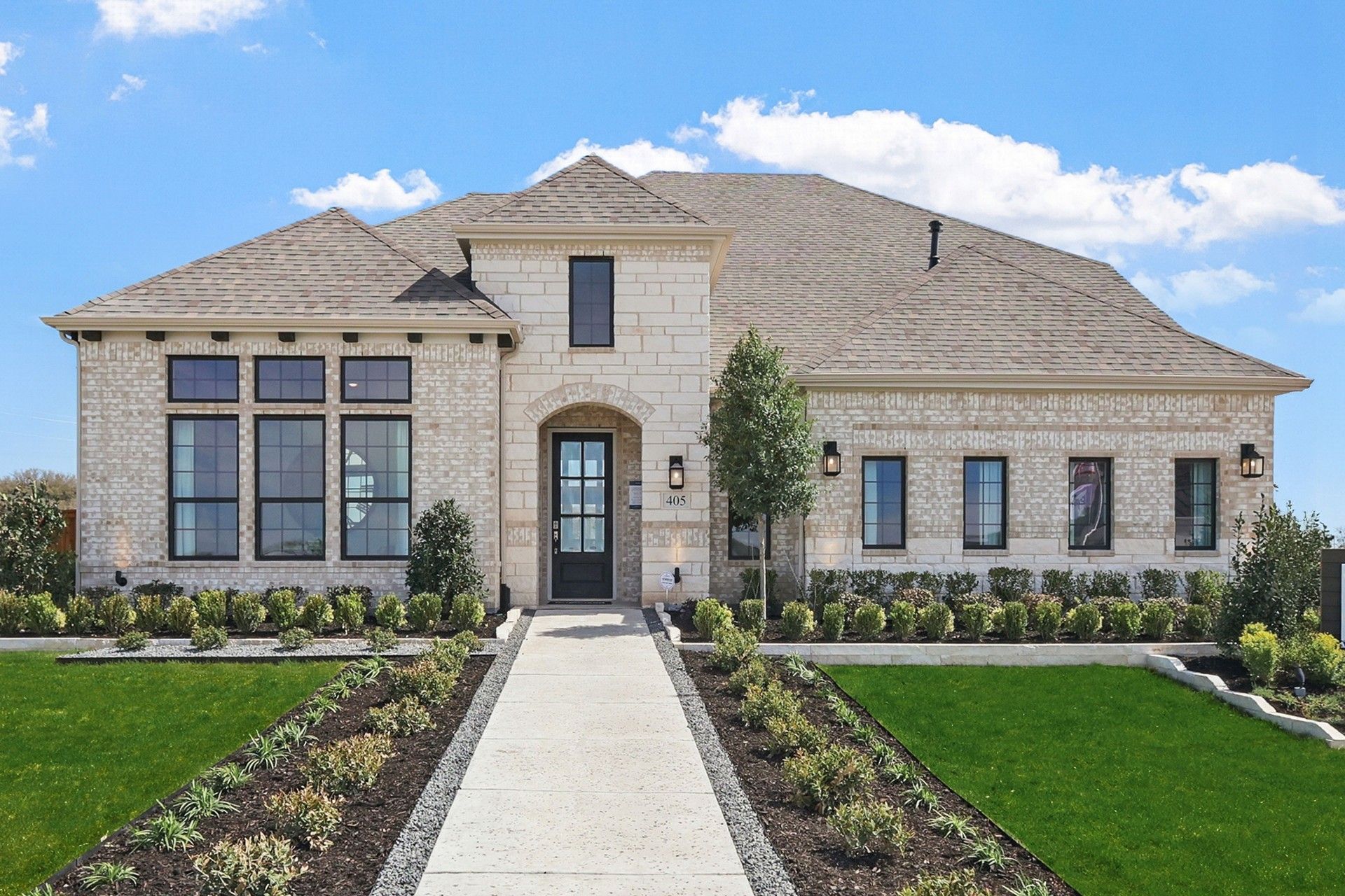 Distinctive brick facade and expansive windows define this exquisite Kelly Ranch residence.