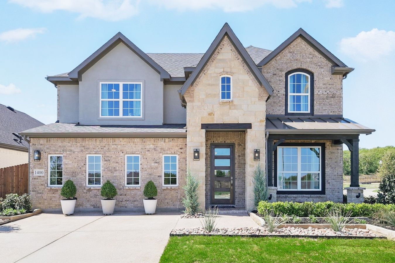 Exquisite brick facade and modern gabled architecture in prestigious Green Oaks Preserve.