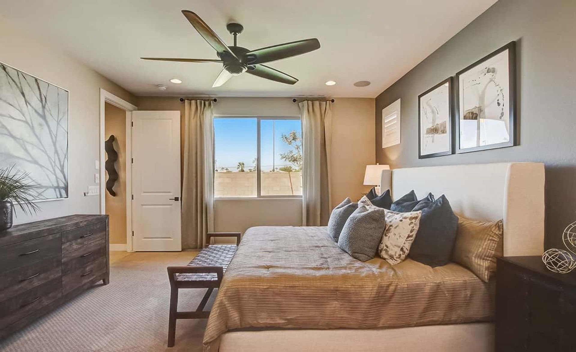 Elegant beige interiors with artful decor define this exquisite bedroom at Castillo, Anderson Parc, Arizona.