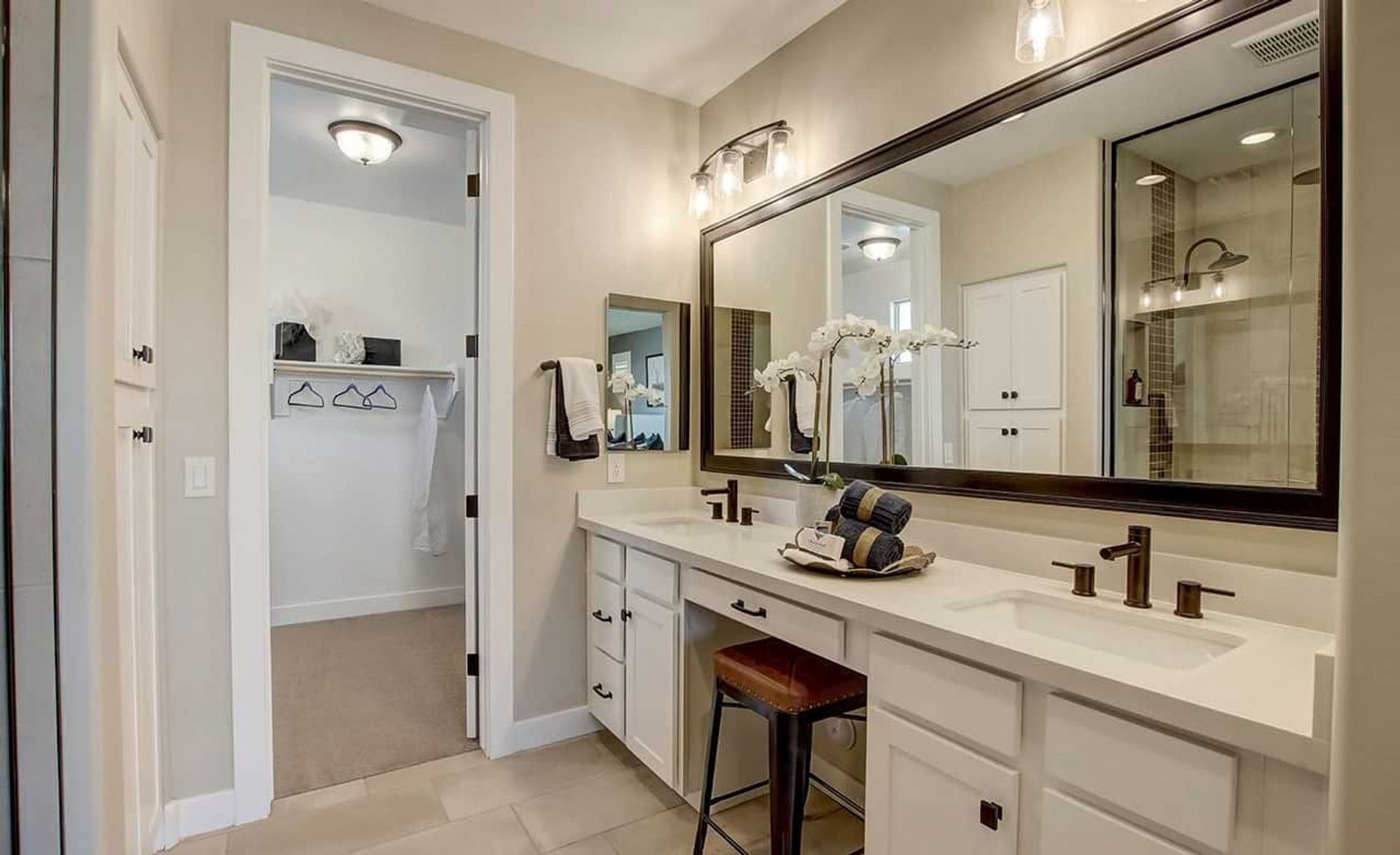 Discover elegance in this Anderson Parc bathroom, featuring bronze fixtures and expansive vanity space.