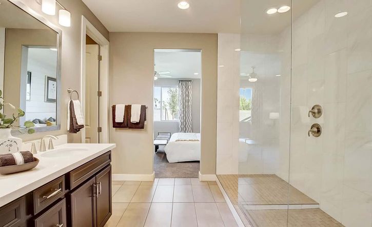 Discover opulent design with a sleek glass shower and dual vanity at Castillo, Anderson Parc.