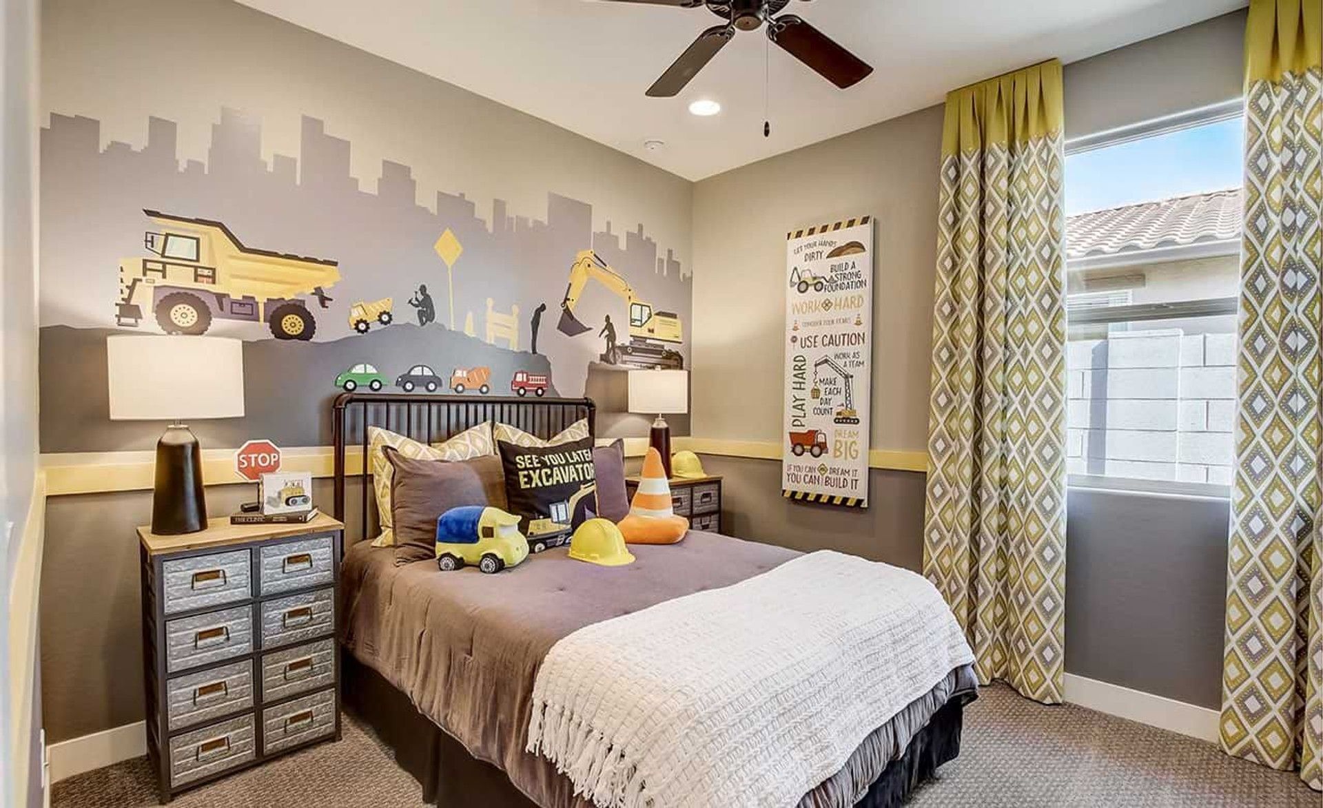 Bespoke construction mural adorns a sophisticated child's room, contrasted by elegant drapery. Castillo at Anderson Parc.