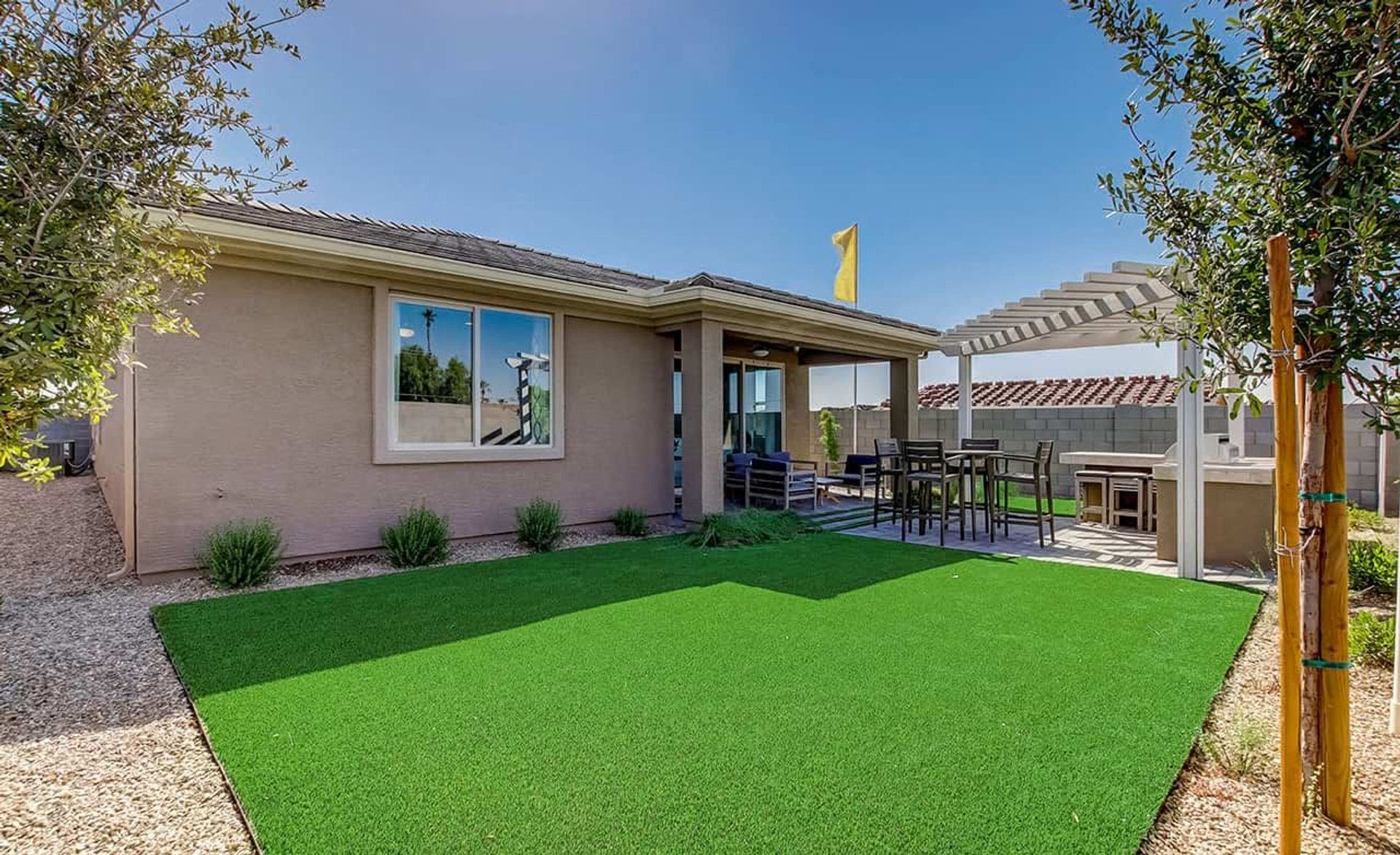 Experience luxury outdoor living with a chic pergola-covered patio in Anderson Parc, Arizona.