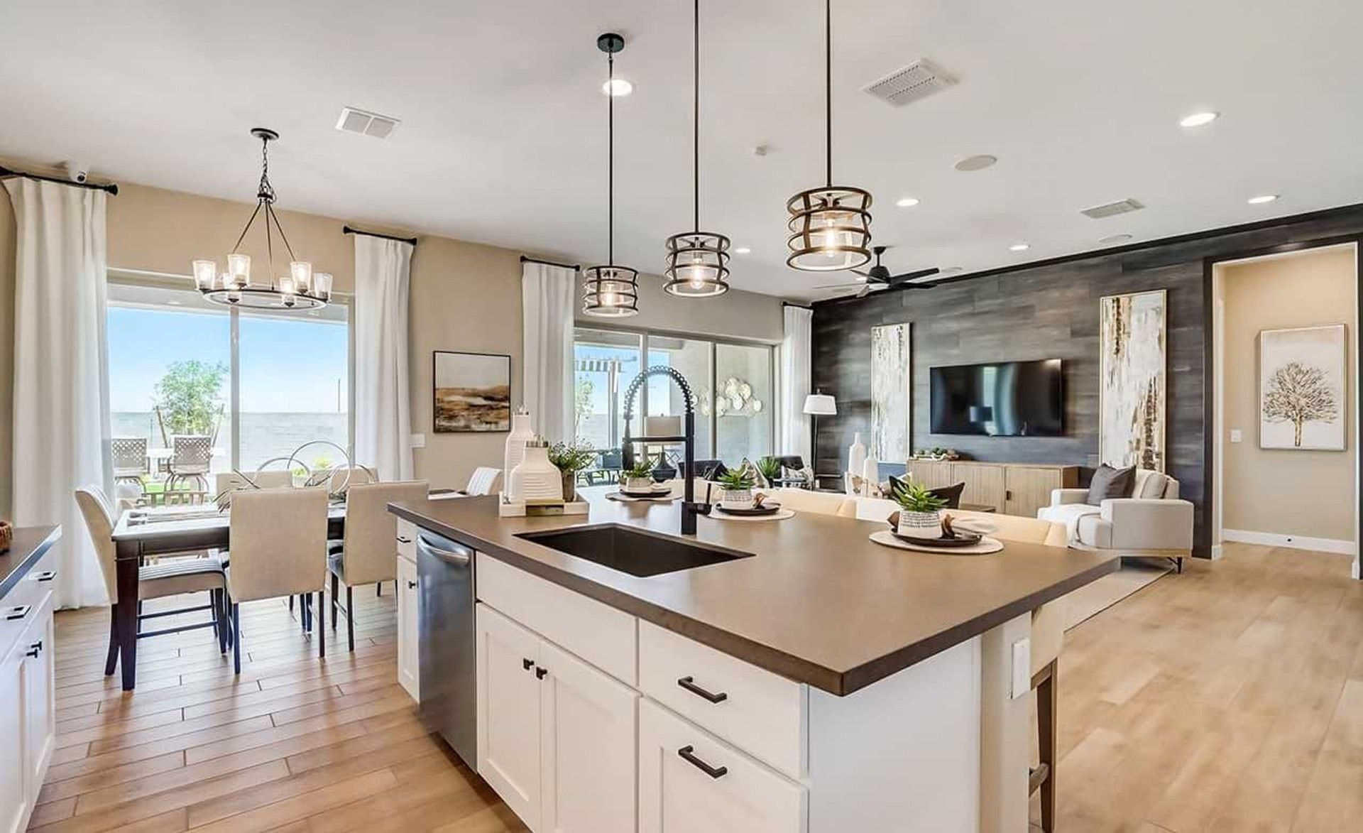 Luxurious wood floors and sleek pendant lighting in Canyon Views epitomize sophisticated modern living.
