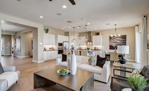Luxurious open layout features sleek white cabinetry and modern lighting. Located in prestigious Canyon Views Hacienda.