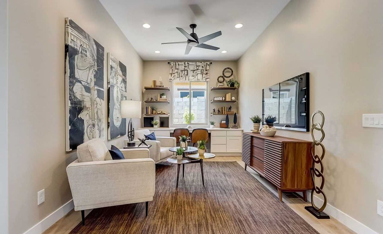 Luxurious living room features abstract art, sleek cabinetry, and a modern ceiling fan in Canyon Views.