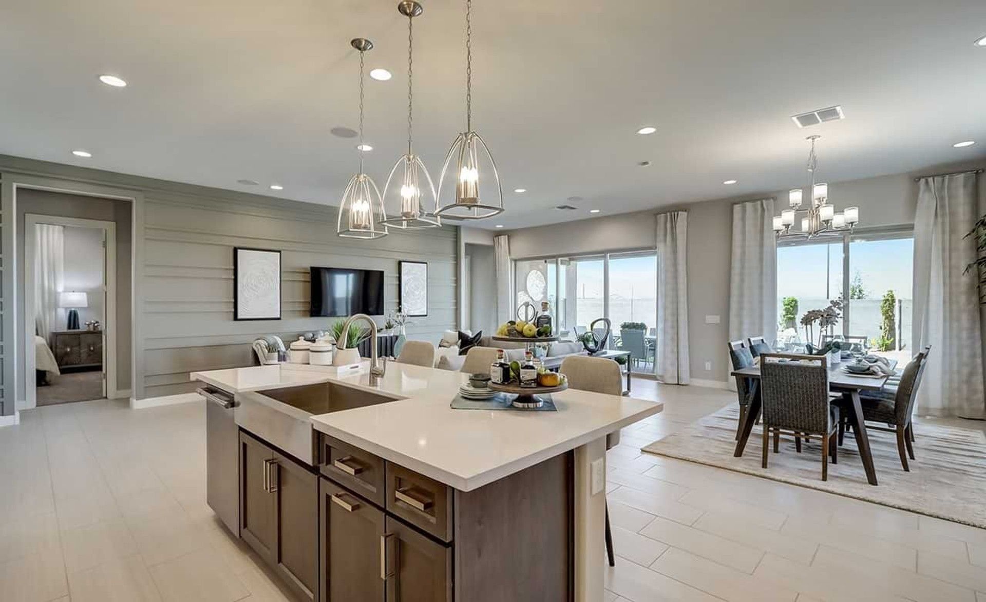 Elegant kitchen features chic pendant lighting and expansive windows, offering luxury living in Hacienda community.