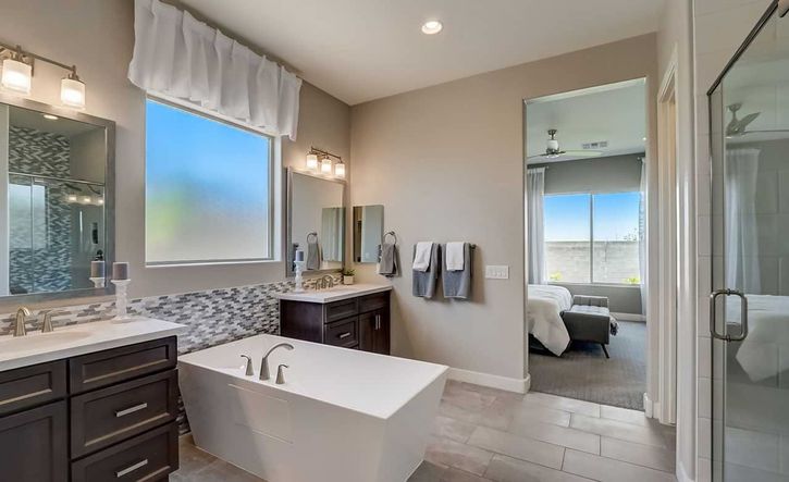 Exquisite freestanding tub and dark wood cabinetry in a serene Hacienda community bathroom.