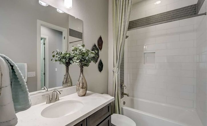 Elegant white tiling and sophisticated fixtures in Canyon Views' elite Hacienda location.