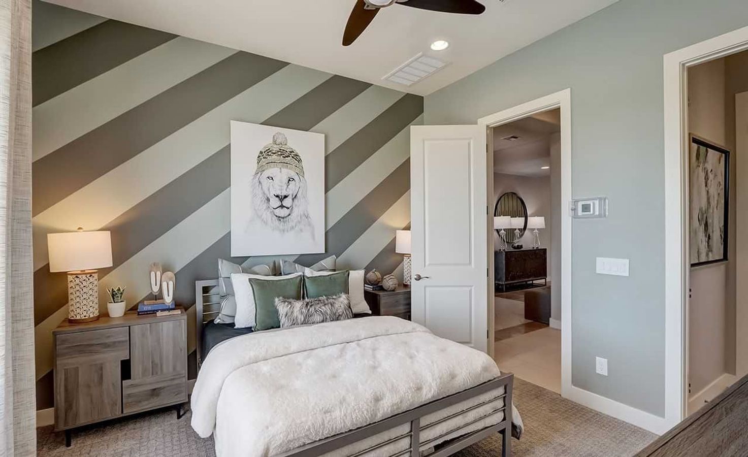 Experience upscale living with a sophisticated striped accent wall and plush textures in Hacienda's Canyon Views.