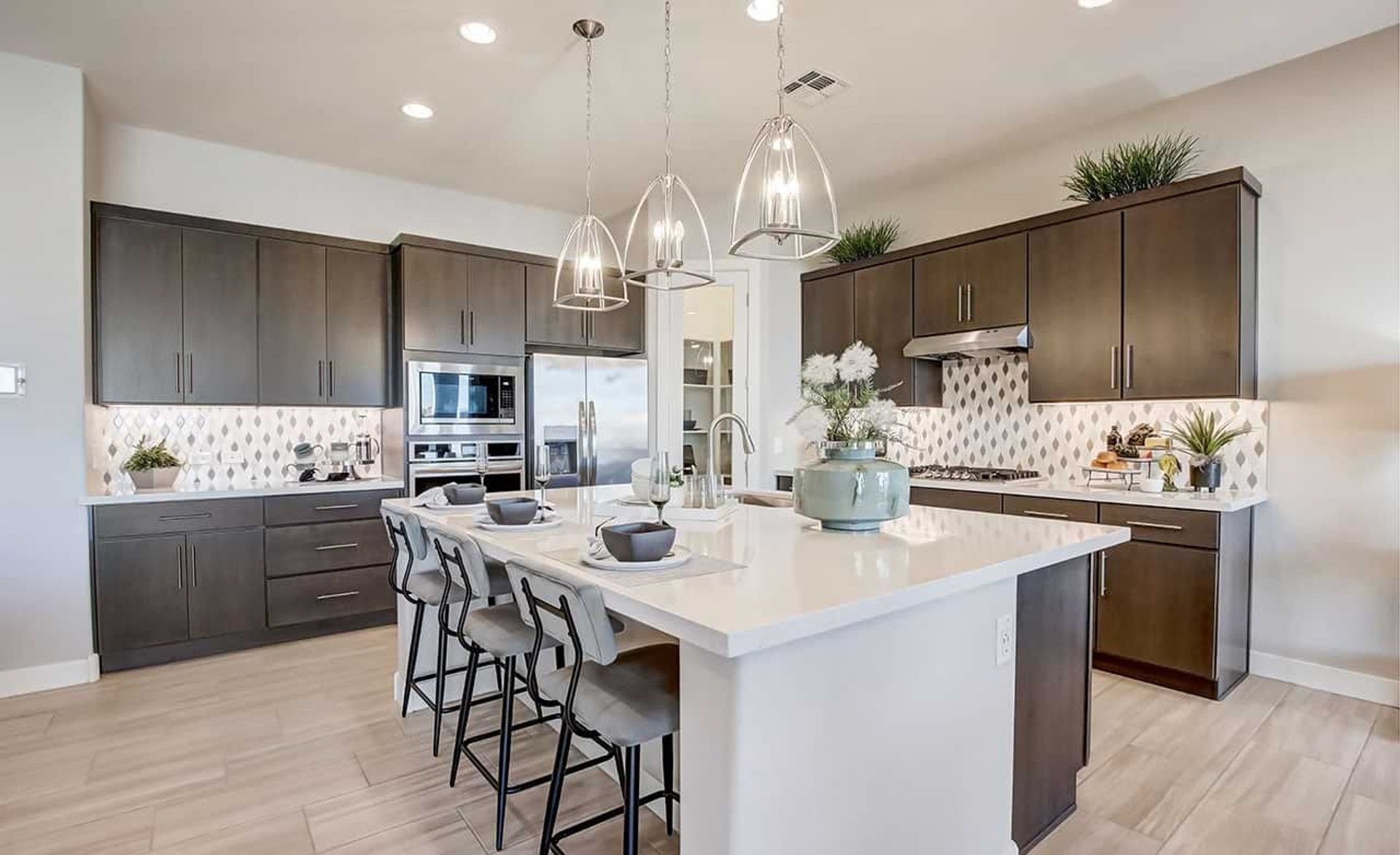 Discover elegance in Mirada Crossing's kitchen with sleek cabinetry, quartz island, and gourmet appliances.