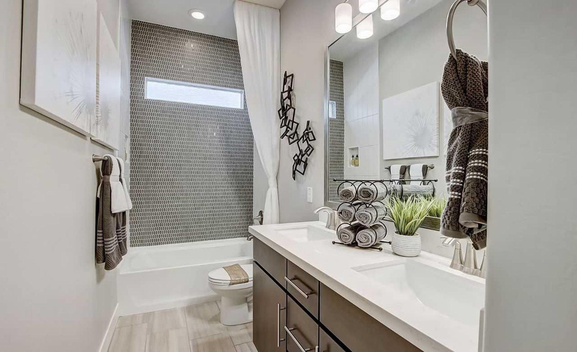 Chic mosaic tiles and sleek vanity define this luxury bathroom at Mirada Crossing.