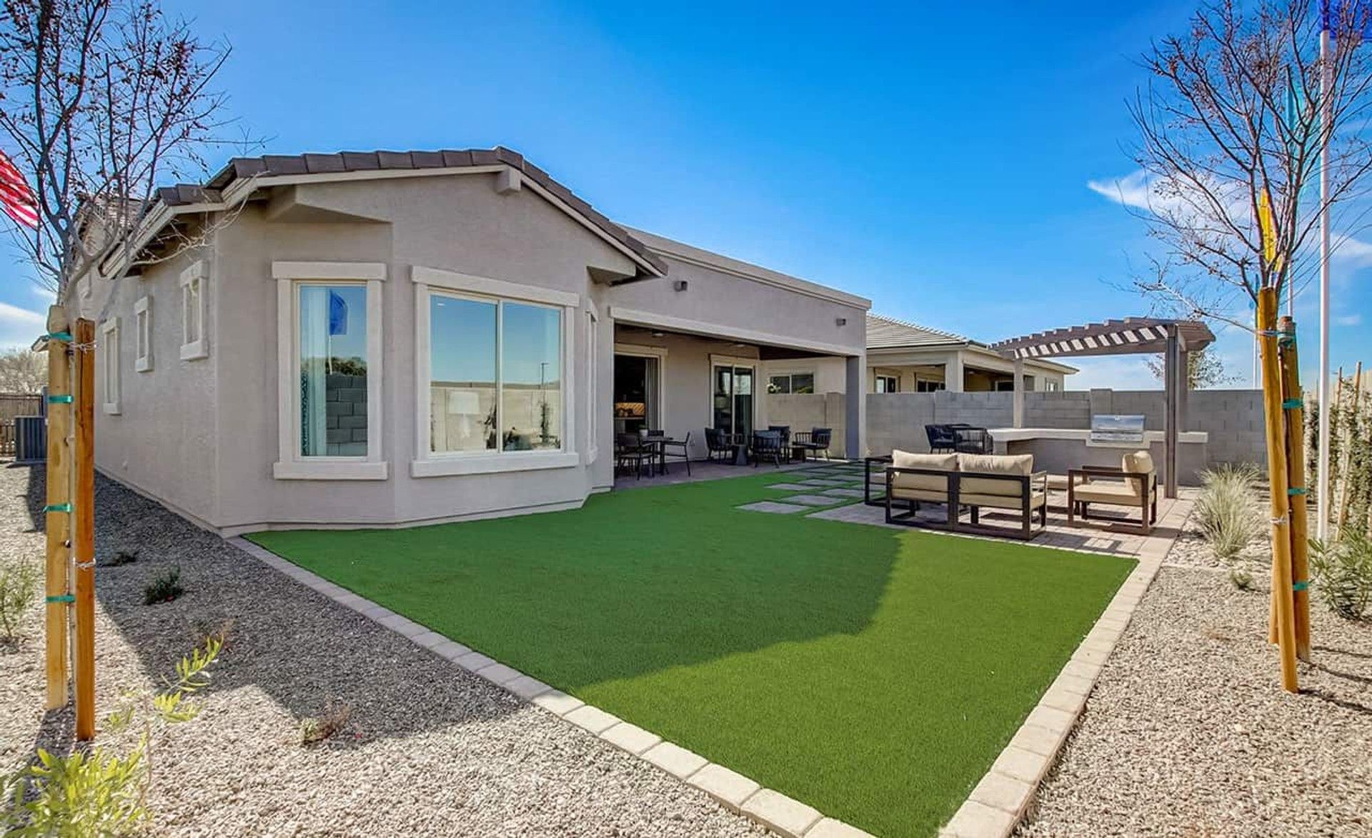 Experience luxury living with a stylish pergola and paved patio in Mirada Crossing, set against a serene landscape.