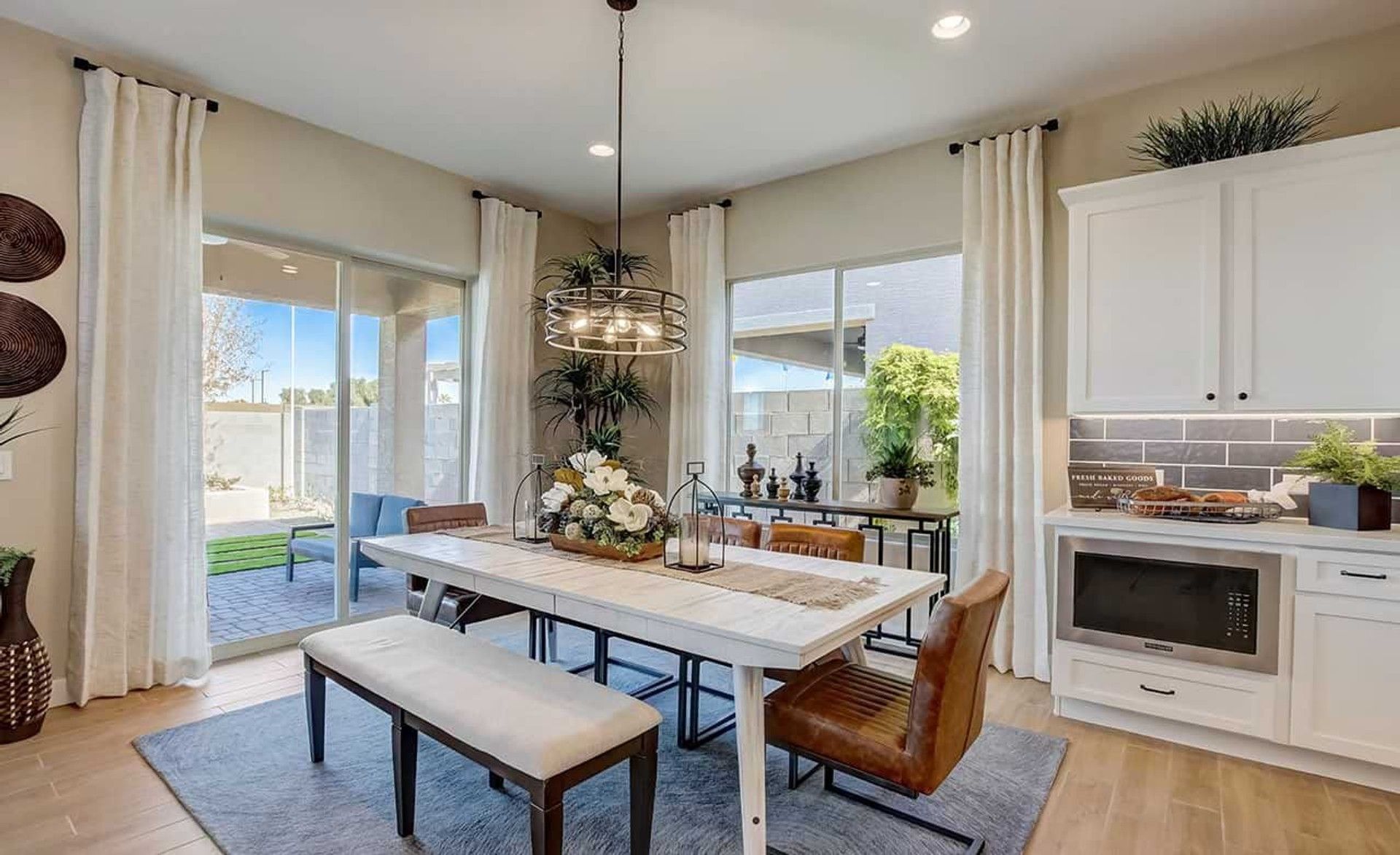 Experience luxury with expansive windows and chic lighting in Mirada Crossing's modern dining space.