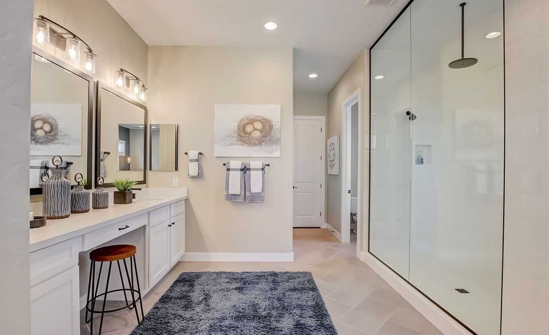 Experience opulence with a spacious glass shower and double vanity. Elegantly crafted in Arizona's Mirada Crossing.
