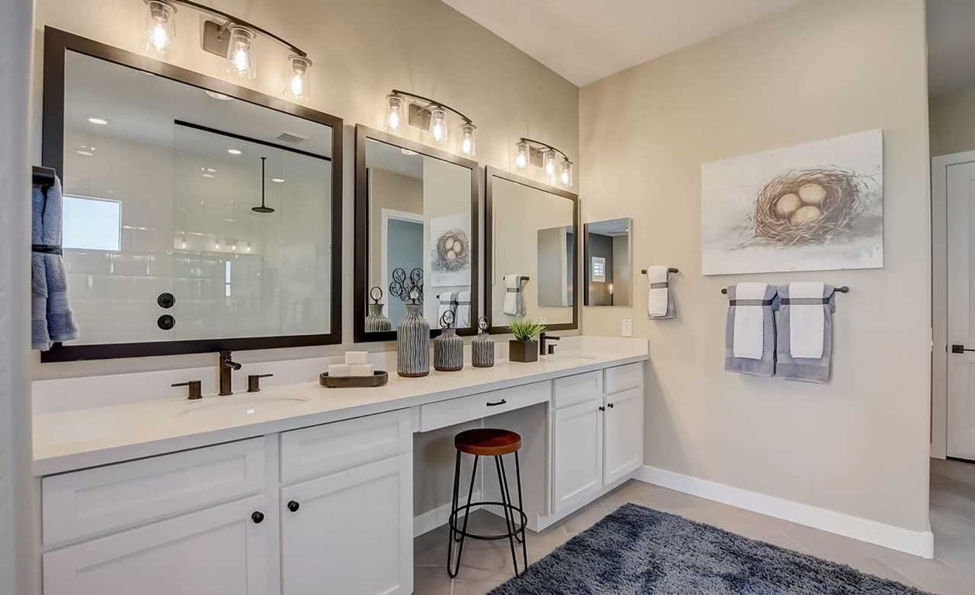 Elegant dual vanity with sleek fixtures and ambient lighting in Mirada Crossing, enhancing modern luxury.