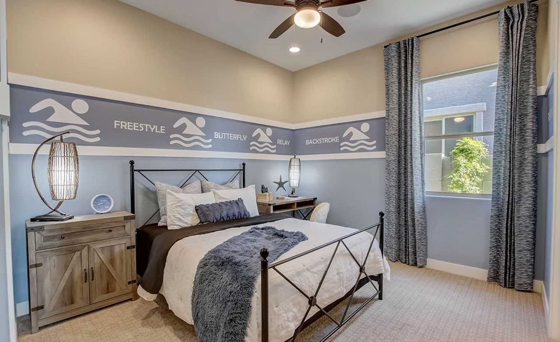 Elegant bedroom with swim mural, wrought iron bed, and bespoke lighting at Mirada Crossing.