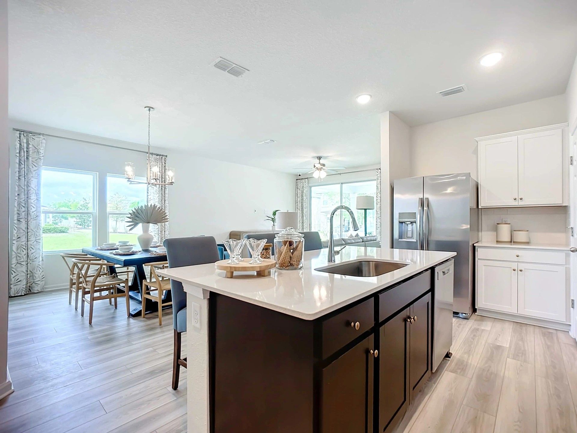 Luxurious kitchen with quartz island, stainless appliances, and designer lighting in Panther Creek.