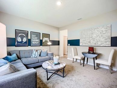 Elegant grey sectional and artful touches create a modern, upscale haven in Panther Creek.