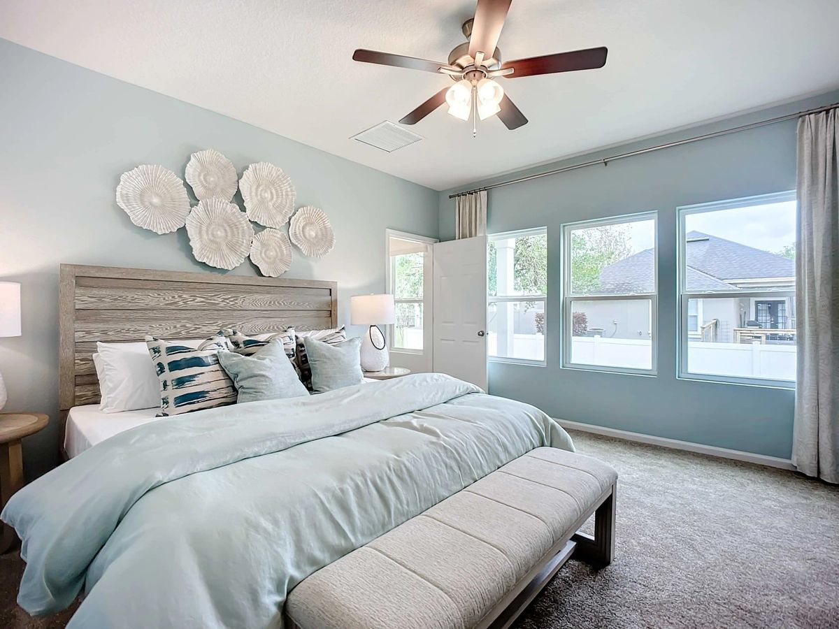 Discover serenity in this Panther Creek bedroom with expansive windows and artistic textures.