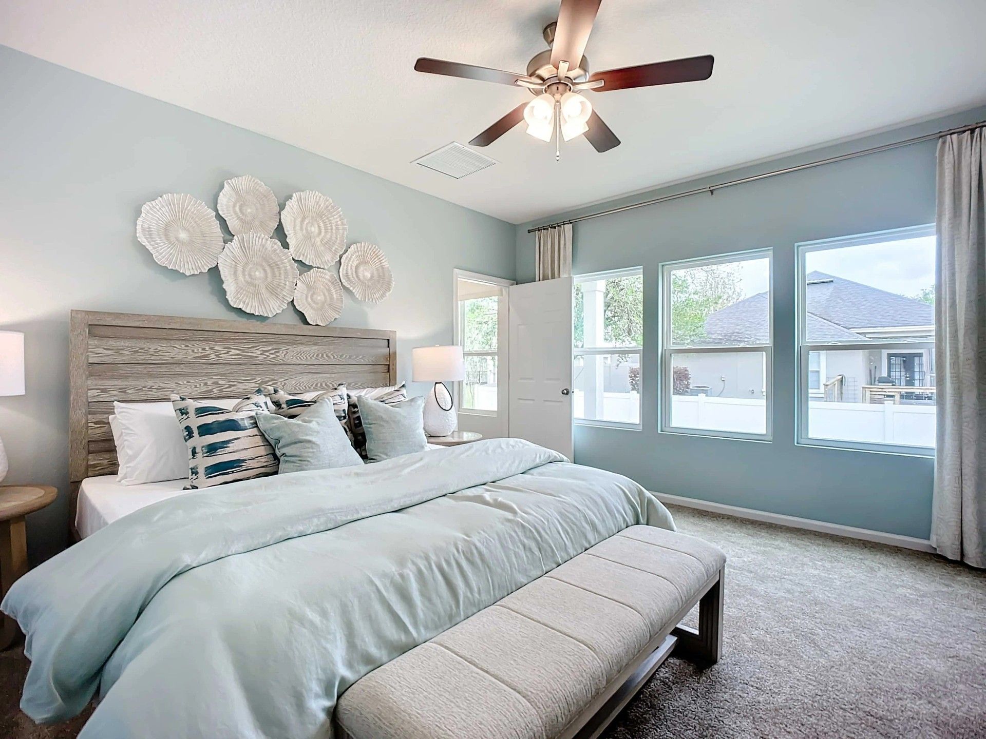 Discover serenity in this Panther Creek bedroom with expansive windows and artistic textures.