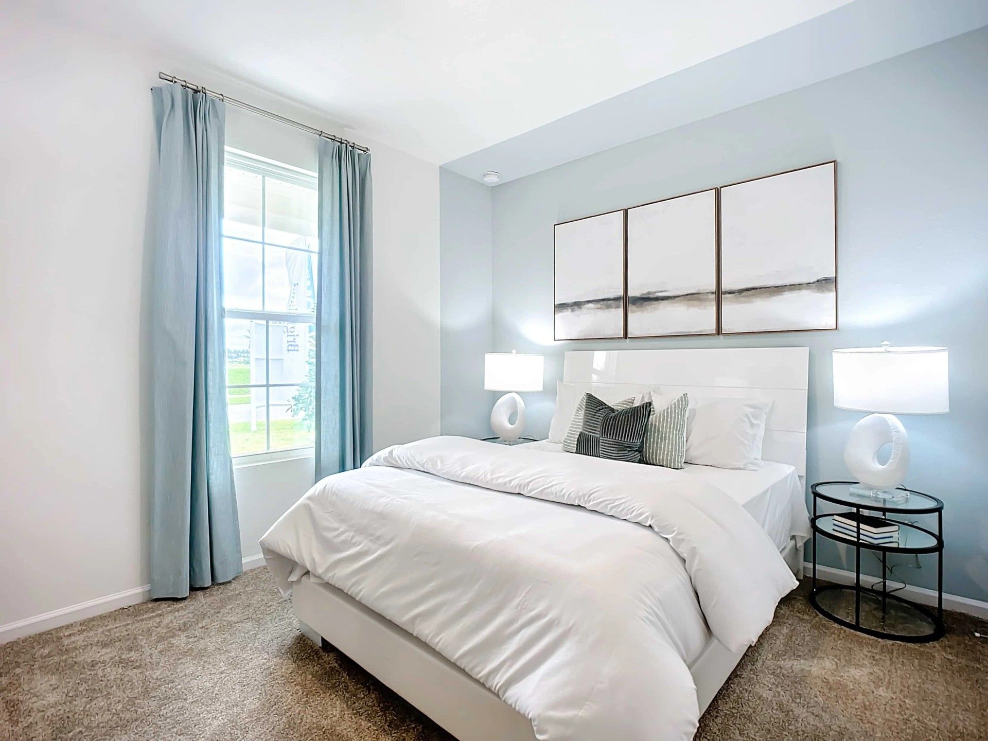 Luxurious bedroom features serene blue walls and plush carpet, offering tranquil elegance in Panther Creek.