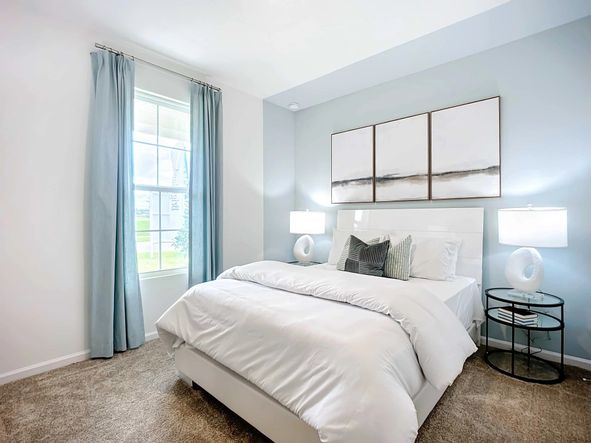 Luxurious bedroom features serene blue walls and plush carpet, offering tranquil elegance in Panther Creek.