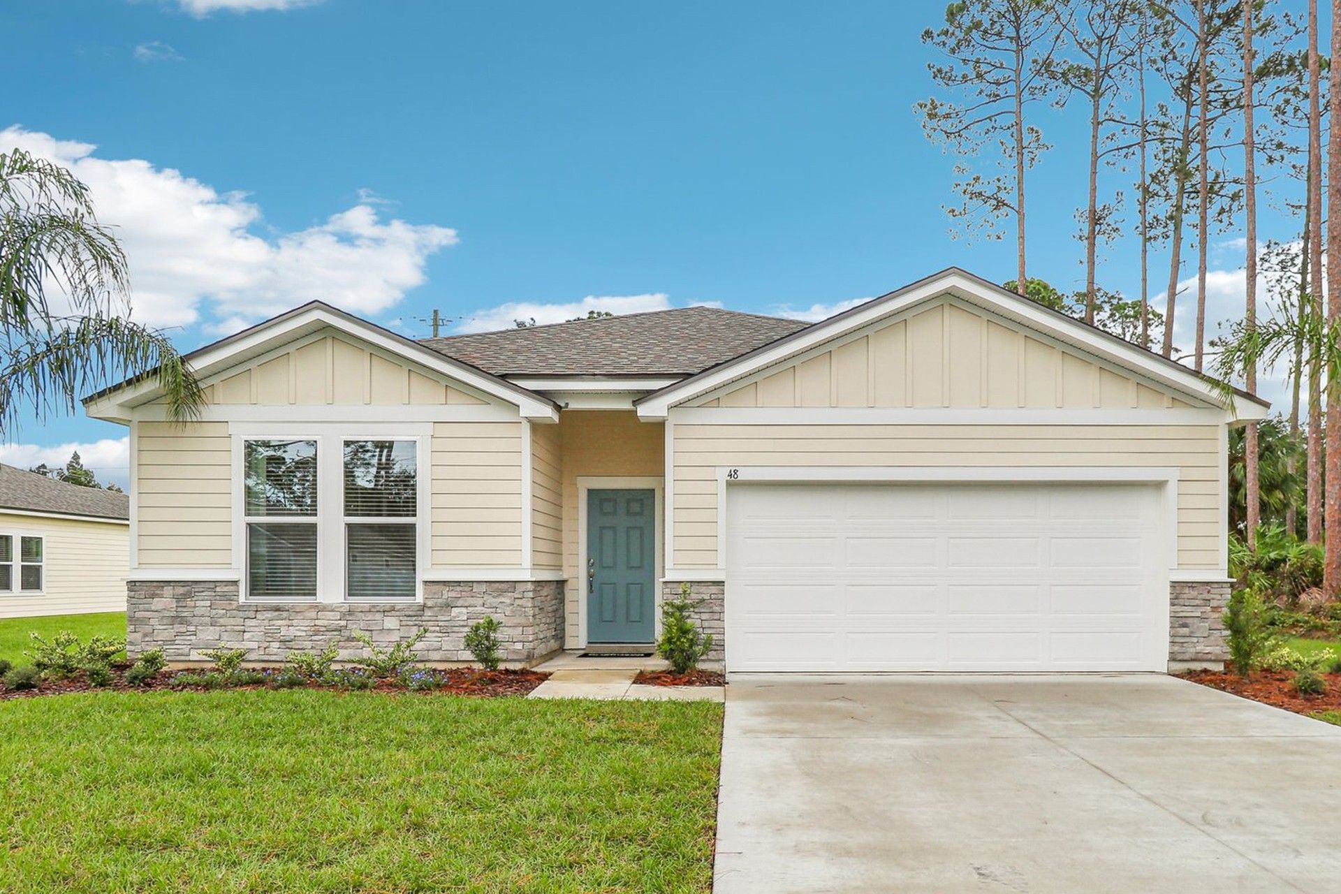 Elegant Palm Coast residence with stone accents and lush landscape embodies timeless sophistication.