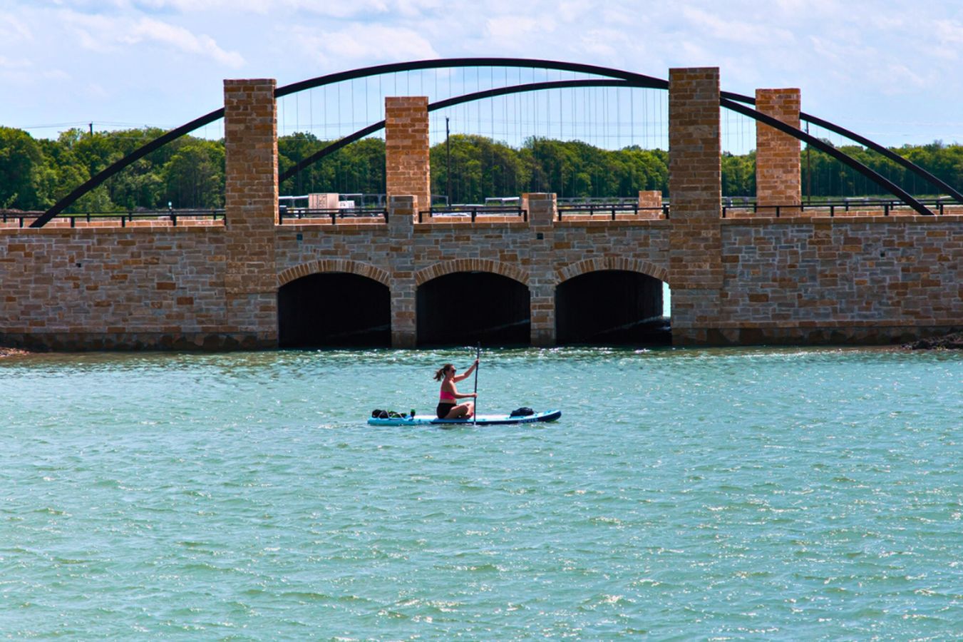 Experience refined living with stunning stone arches and serene waterscape in Solterra Texas.